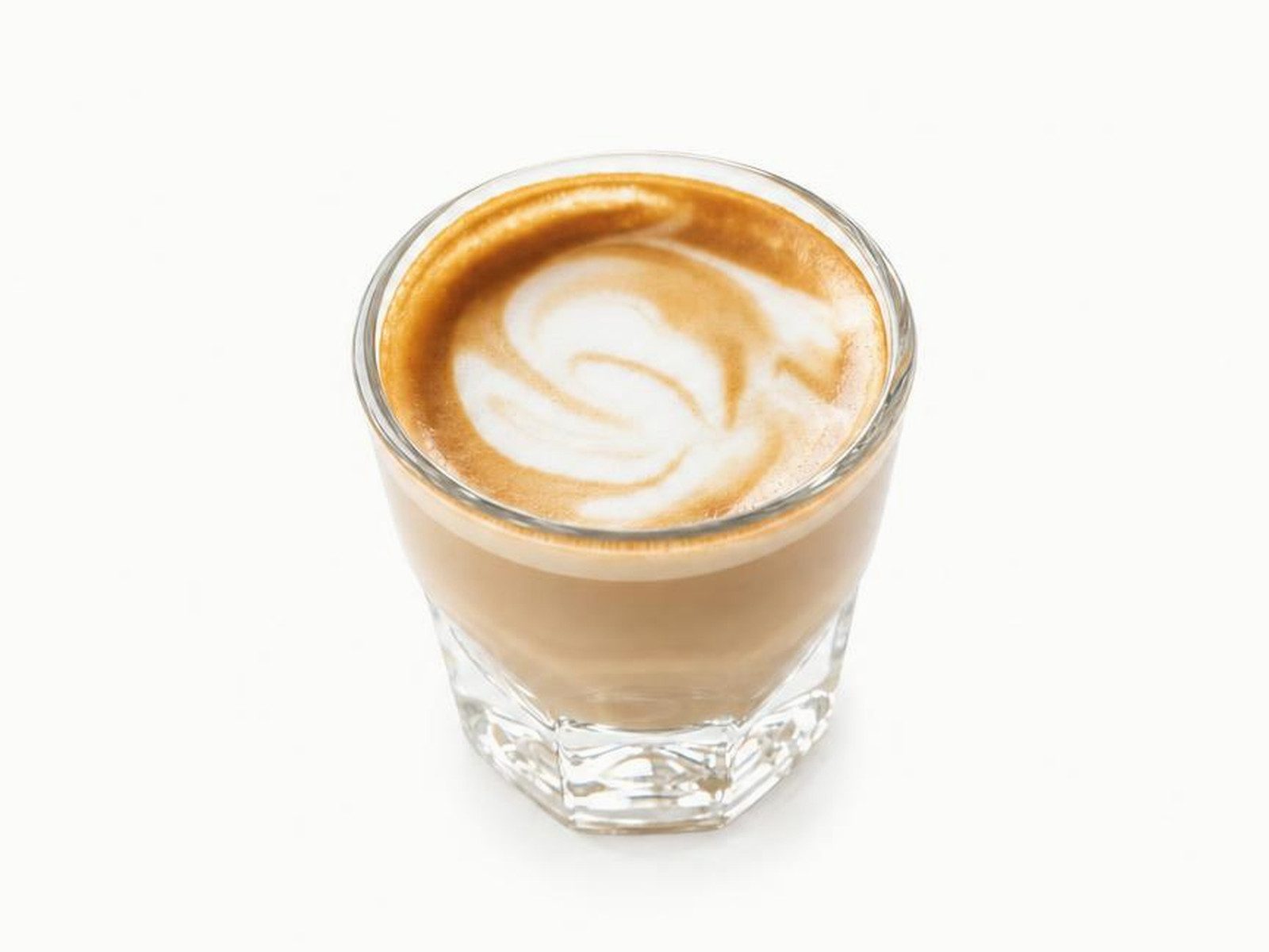 Cortado with latte art in a small faceted glass