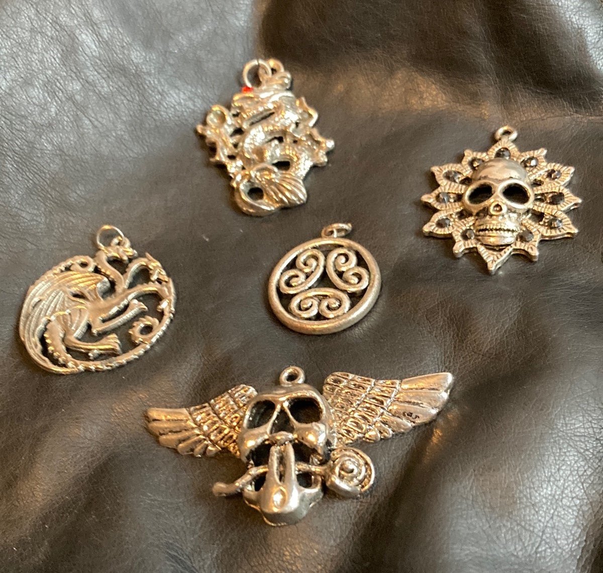Lot of 5 silver tone skull, dragon and circle design pendants