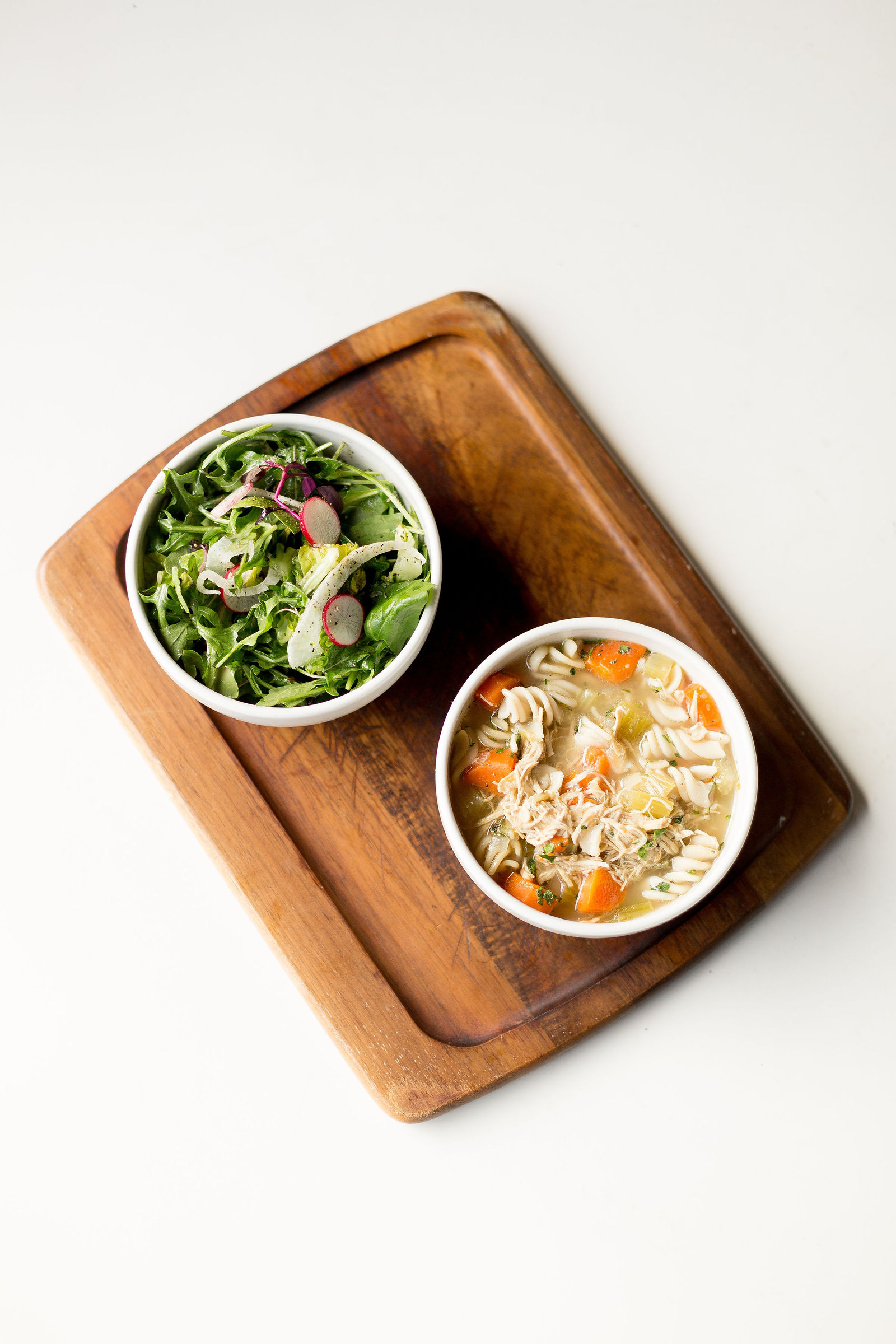 Soup + Salad Board — dairy-free tomato, gf chicken noodle, or soup of the day; salad - mixed greens, or little gem caesar