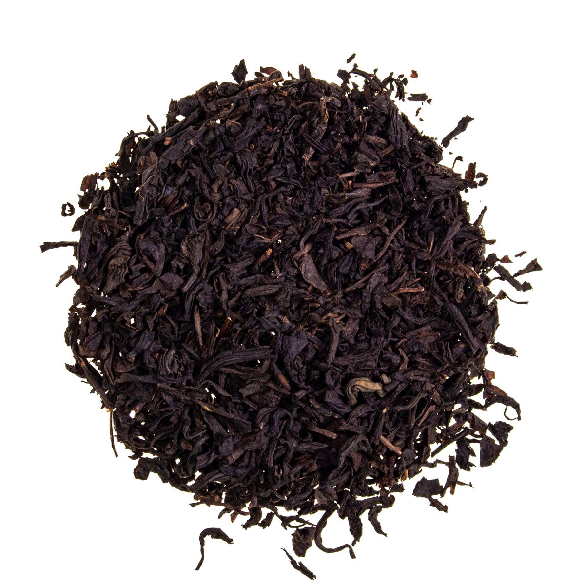 Loose‑leaf Lapsang Souchong tea from Adore Tea, showing dark, twisted smoky leaves in a scattering on a light surface, highlighting its classic campfire aroma.