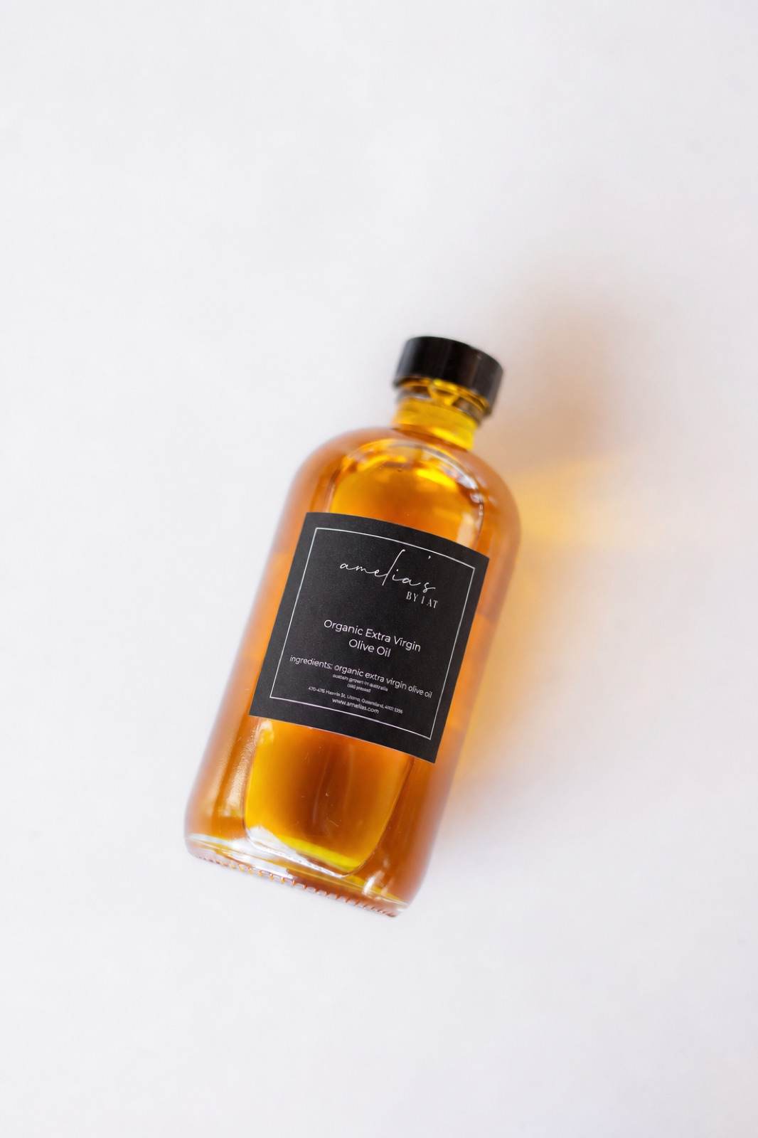 Amelia's Organic Extra Virgin Olive Oil in a clear glass bottle with black cap