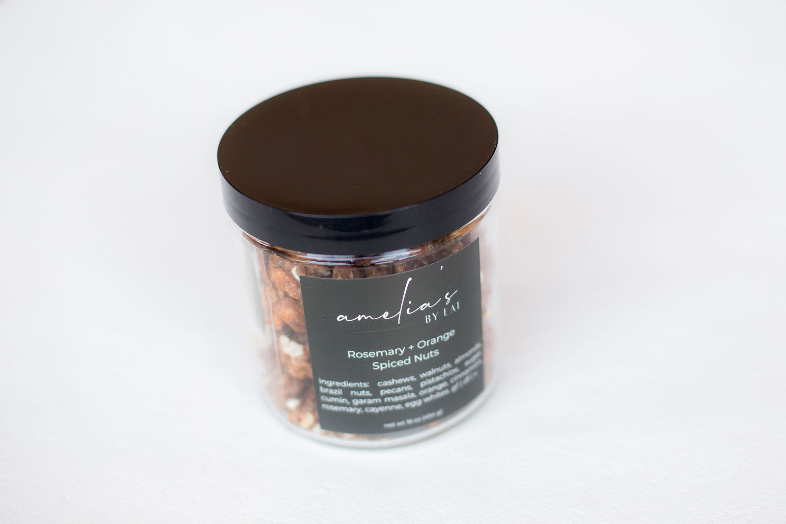 Amelia's Rosemary + Orange Spiced Nuts in a large black-lidded glass jar