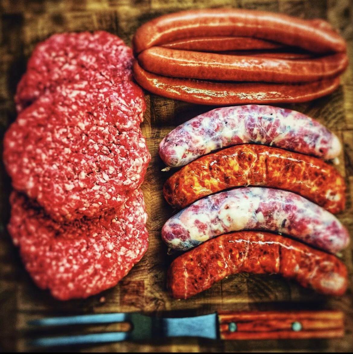 The BVMM Grill Bundle — hand-made patties and sausages laid out ready for the grill