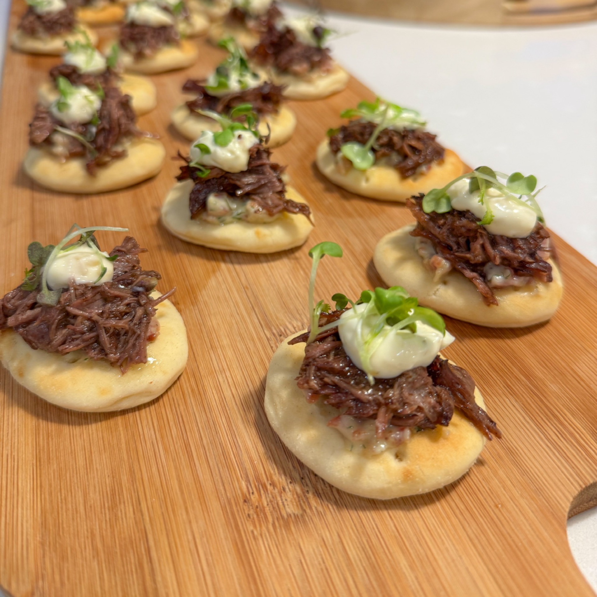 Naan bites platter, bacon and dill cream, pulled beef and herb cream