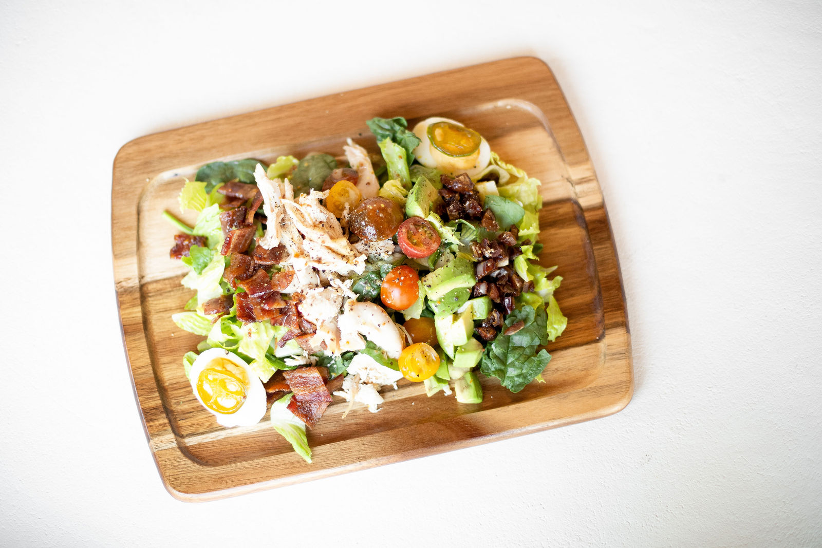 Salad Board — amelia's rotisserie chicken, spicy deviled eggs, nitrate free crispy bacon, avocado, cherry tomatoes, medjool