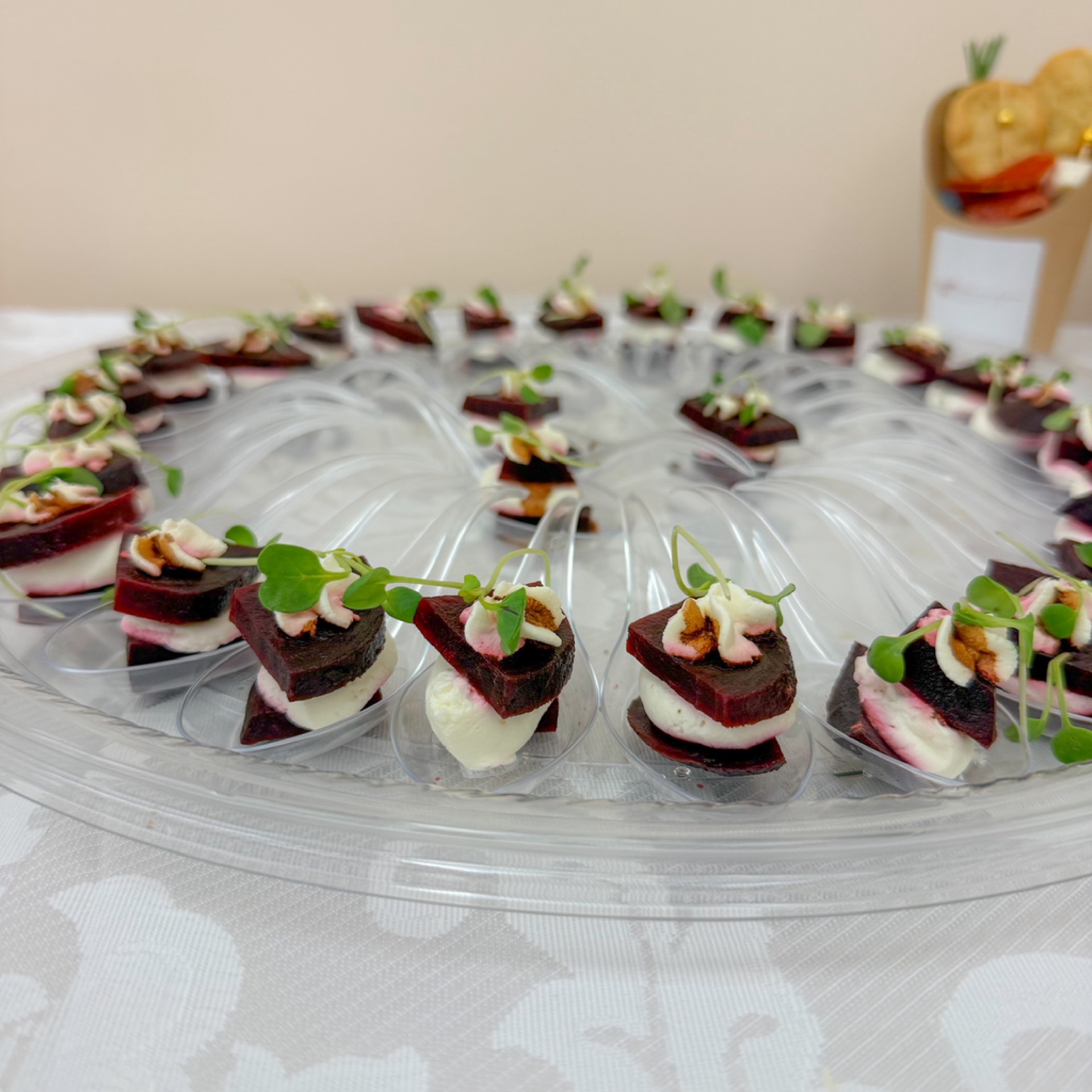 Layered tray of beetroot spoons with balsamic goat cheese cream