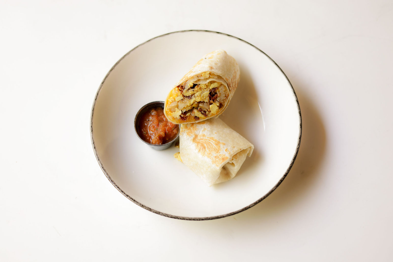 Bacon Breakfast Burrito — local scrambled organic eggs, nitrate-free bacon, roasted potatoes, mozzarella + cheddar, whole