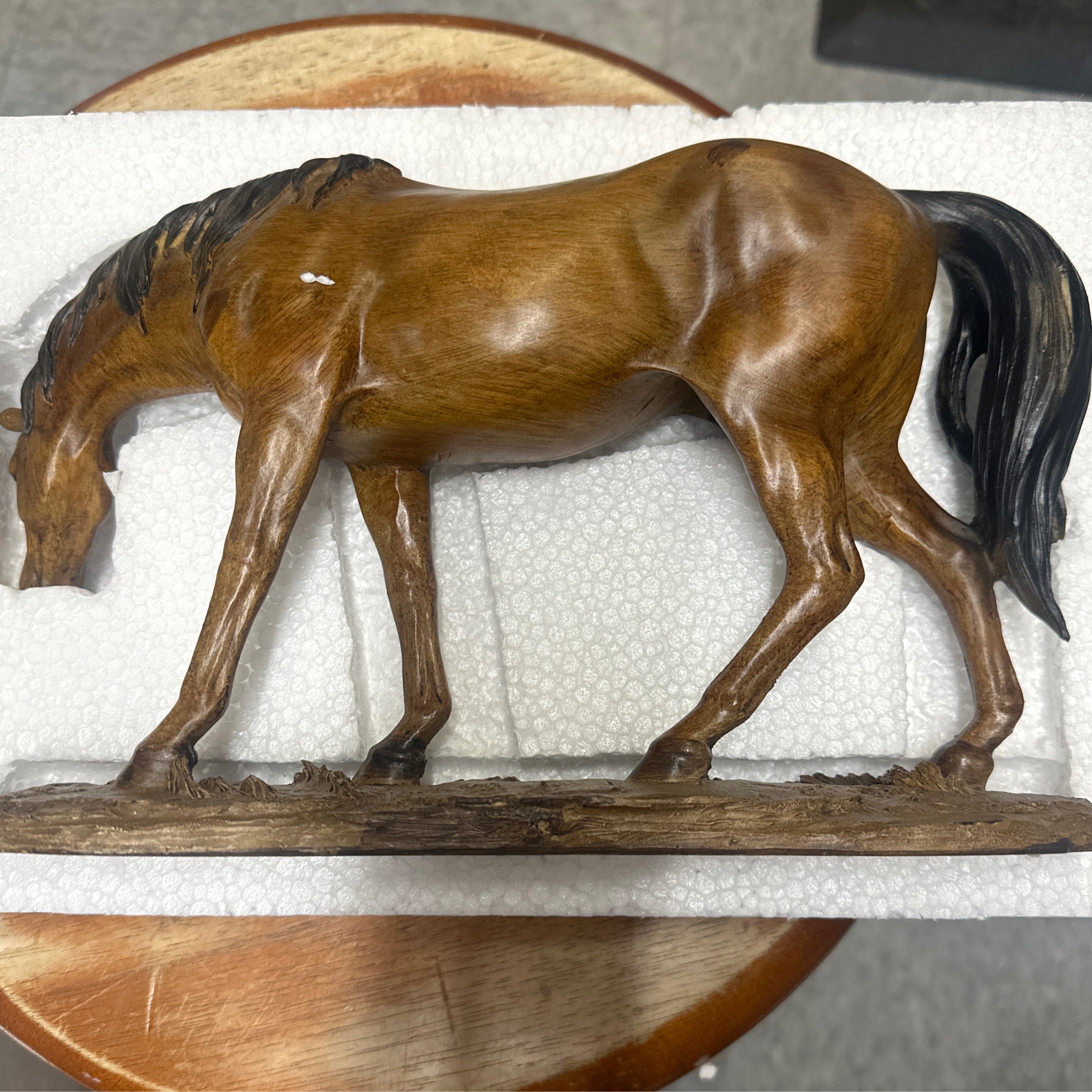 Brown horse walking with head down
