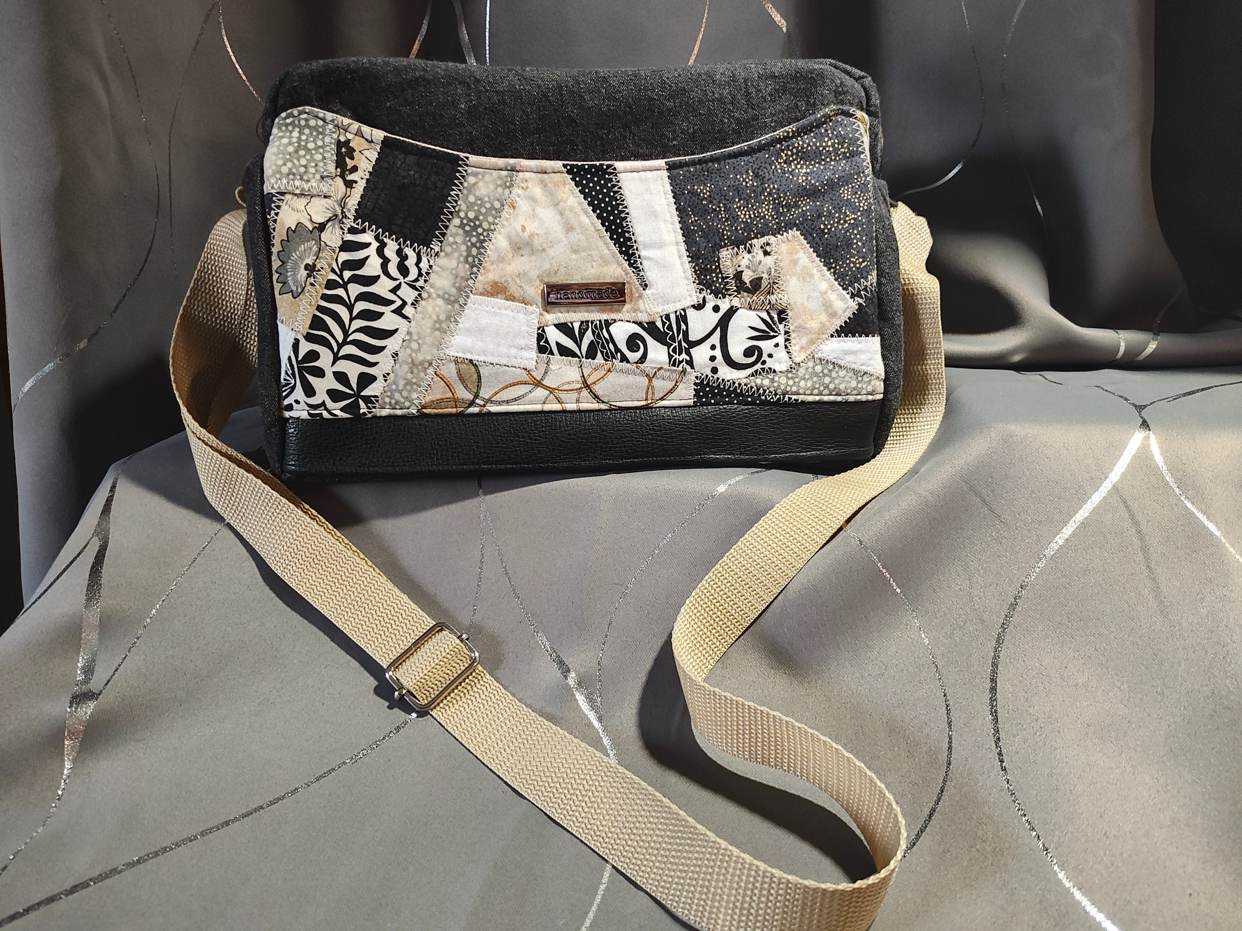 Neutral tan and black handbag with faux leather trim