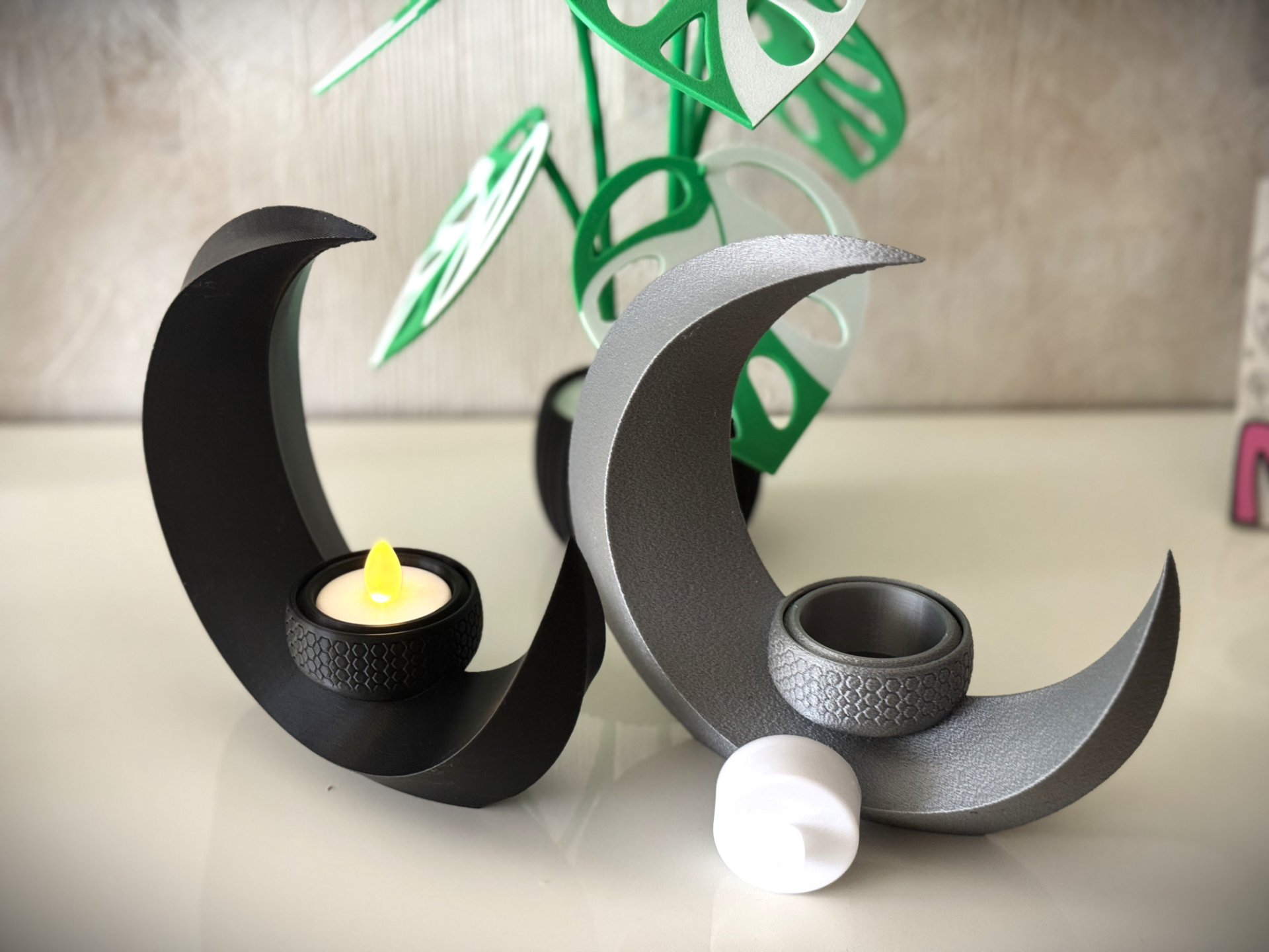 The Crescent Moon Tea Light Holder features an elegant design that creates a warm ambiance in any space. 3D printed from durable materials, it ensures lasting charm and functionality.