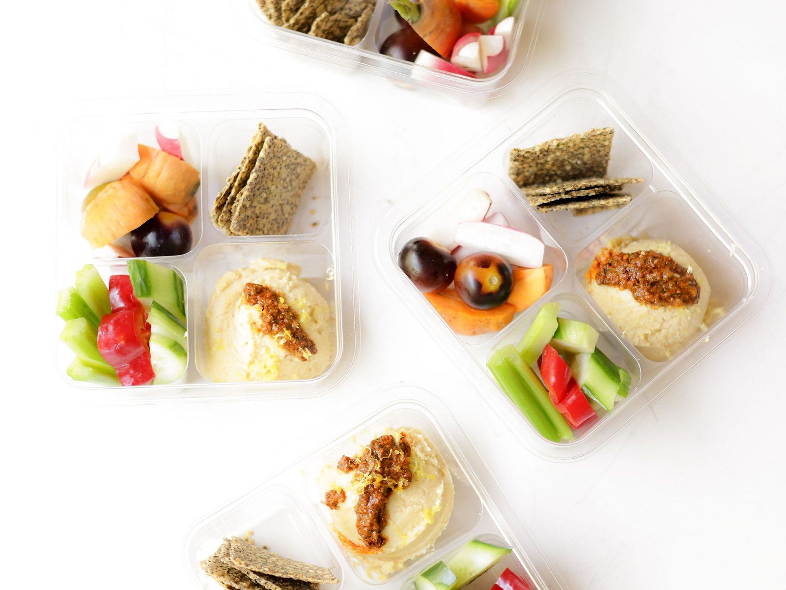 Crudité boxes with hummus, seeded crackers, fresh fruit and cut vegetables