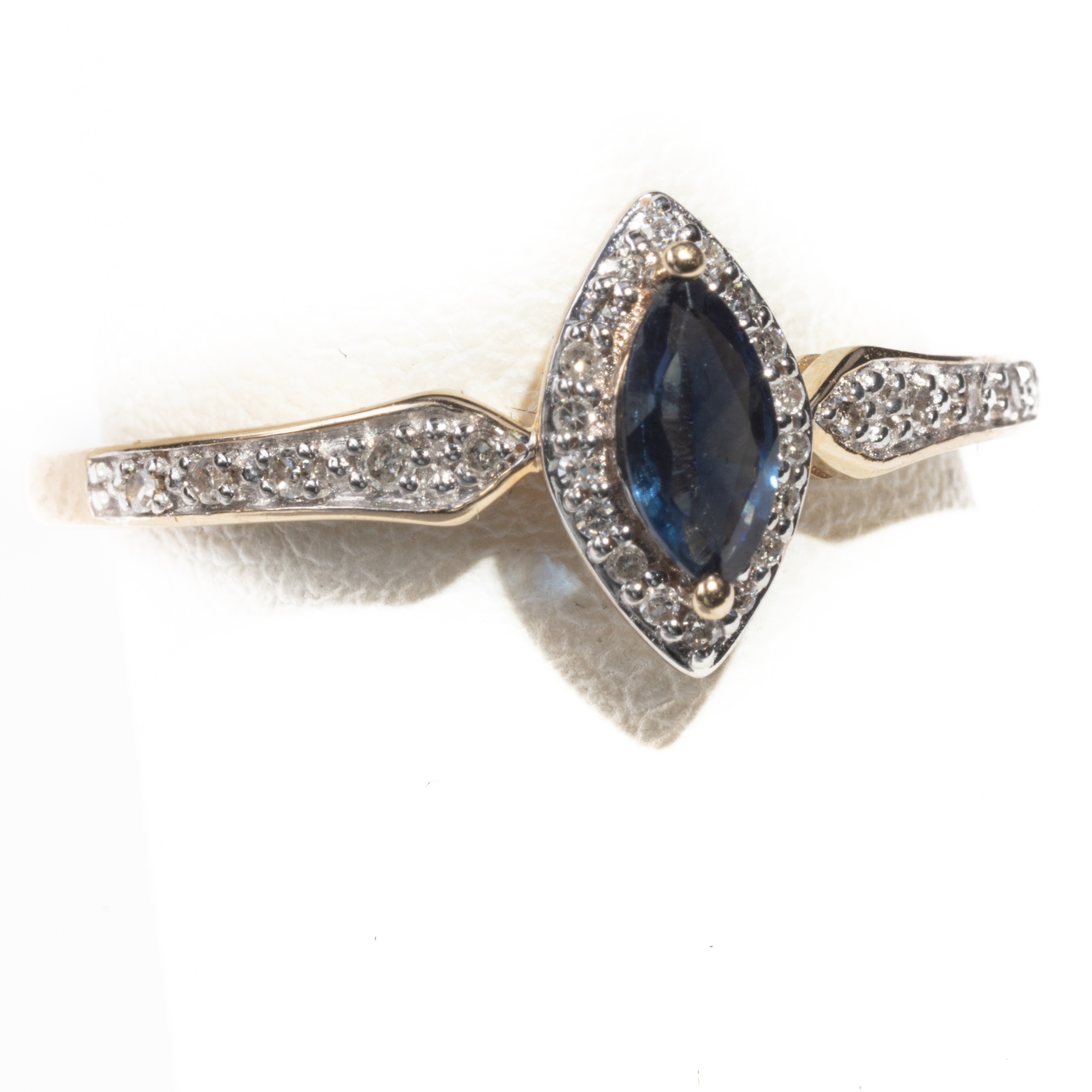 Marquise Cut Sapphire surrounded by Diamonds; Yellow Gold Band