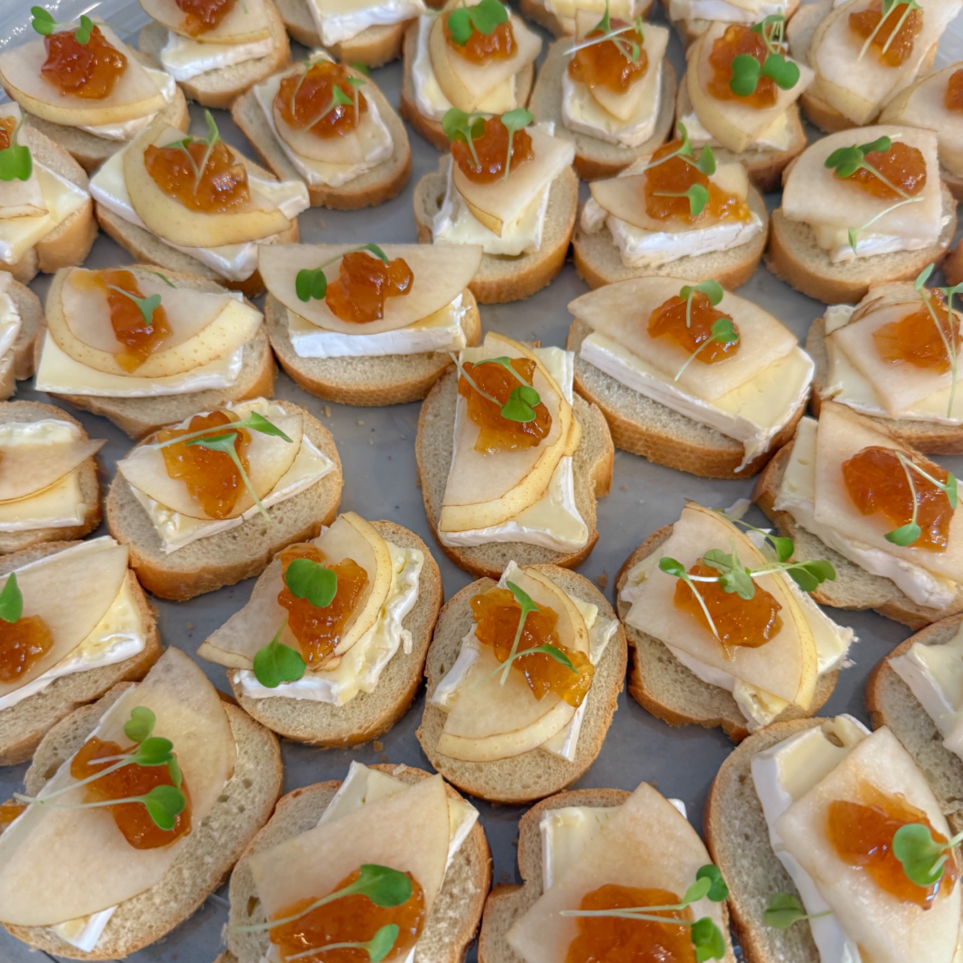 Platter of canapés with brie, Asian pear and onion confit