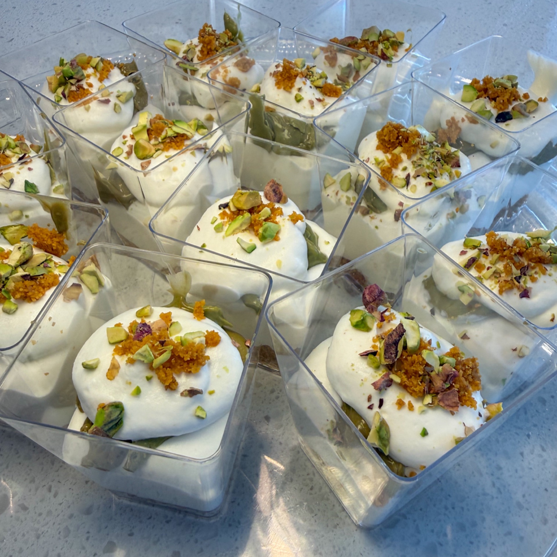 Whipped cream and pistachio cream verrines with crushed pistachios