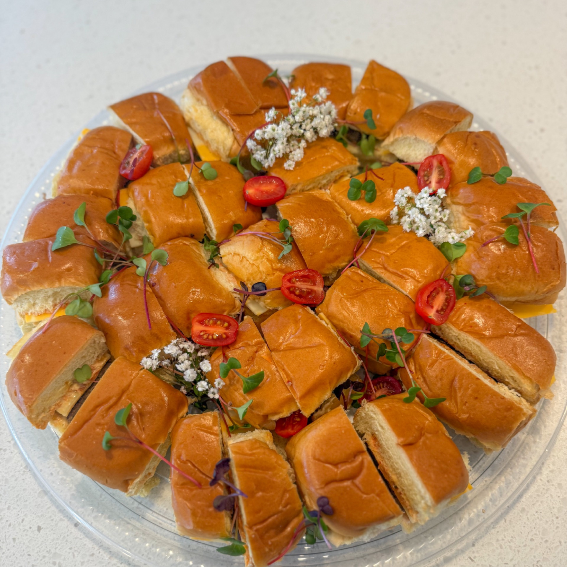 Platter of mini burgers, cheese, kimchi and chipotle mayo
