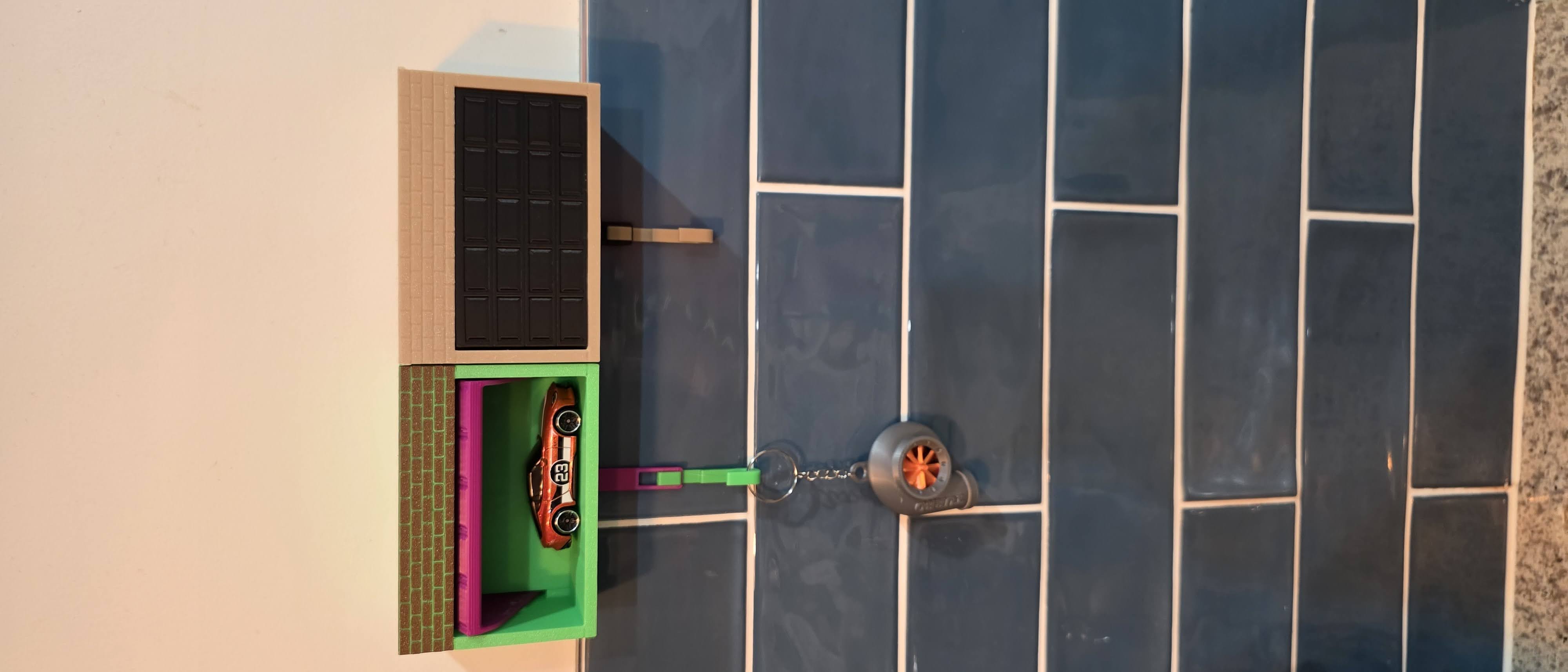 Interactive Pop-Open Garage Door Keyholder