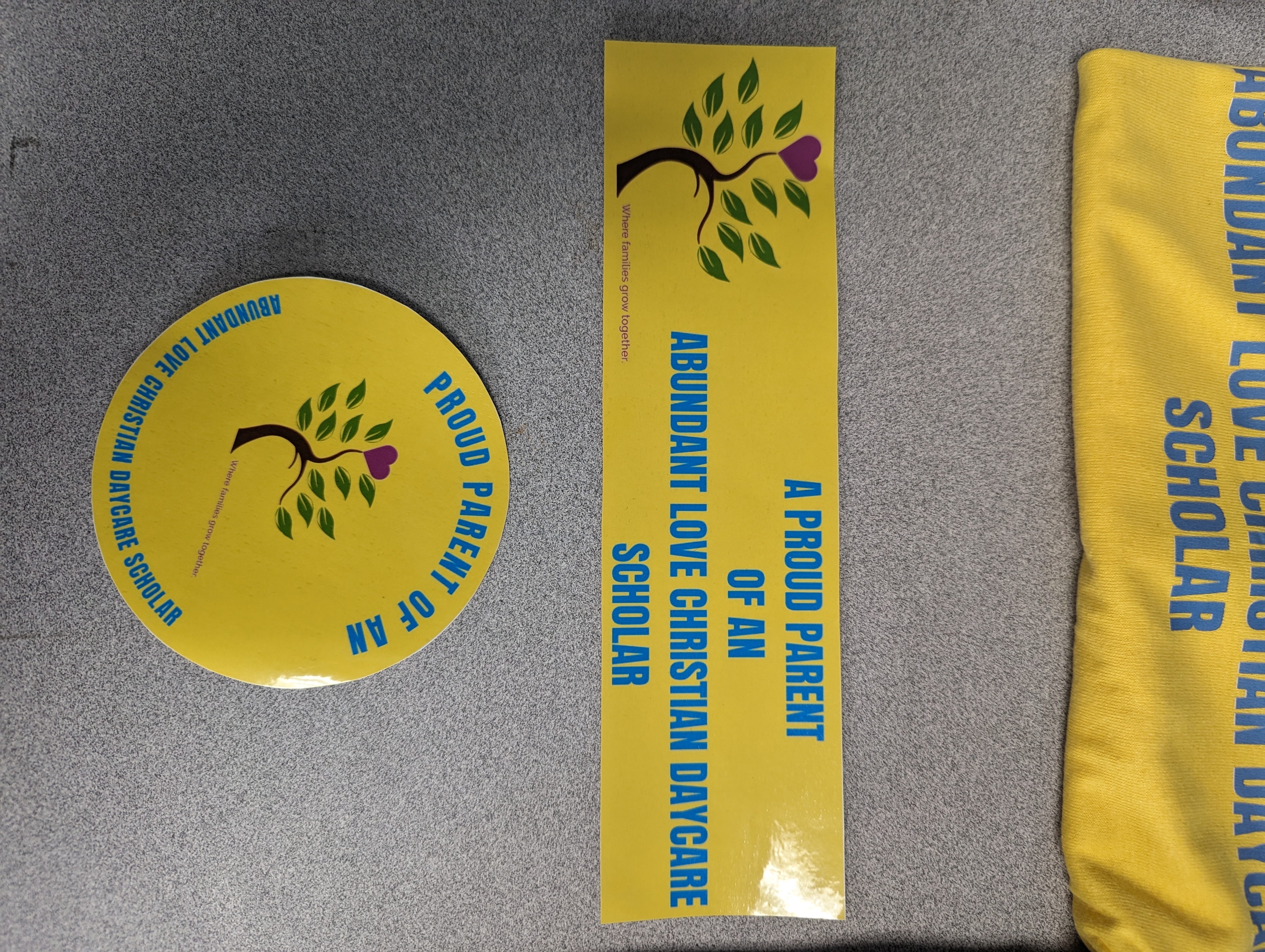 Yellow Sticker "Proud Parent" in Carolina Blue and the school's logo.