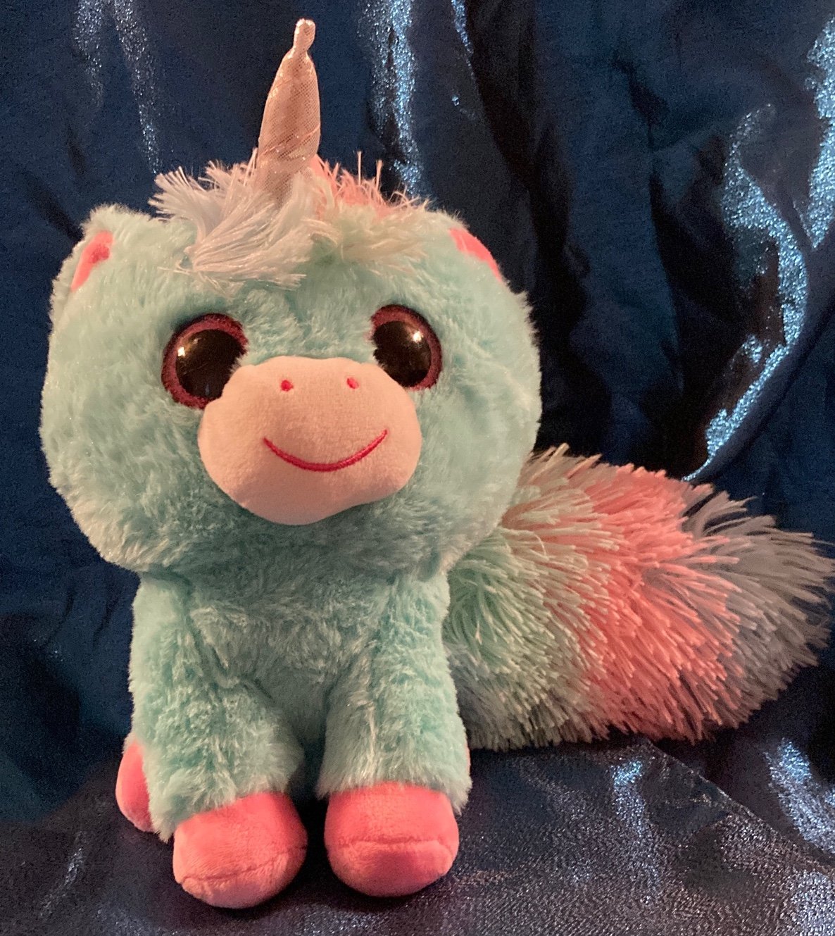 Unicorn with pink ears and teal/ pink fluffy tail