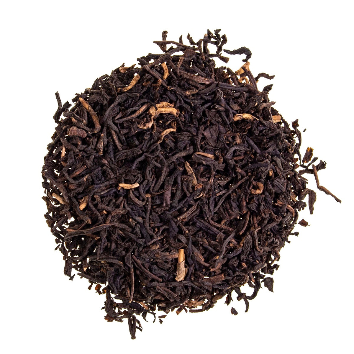 A close-up of decaffeinated Ceylon loose-leaf tea in a silver scoop against a soft pastel background, highlighting the rich amber and dark leaf tones