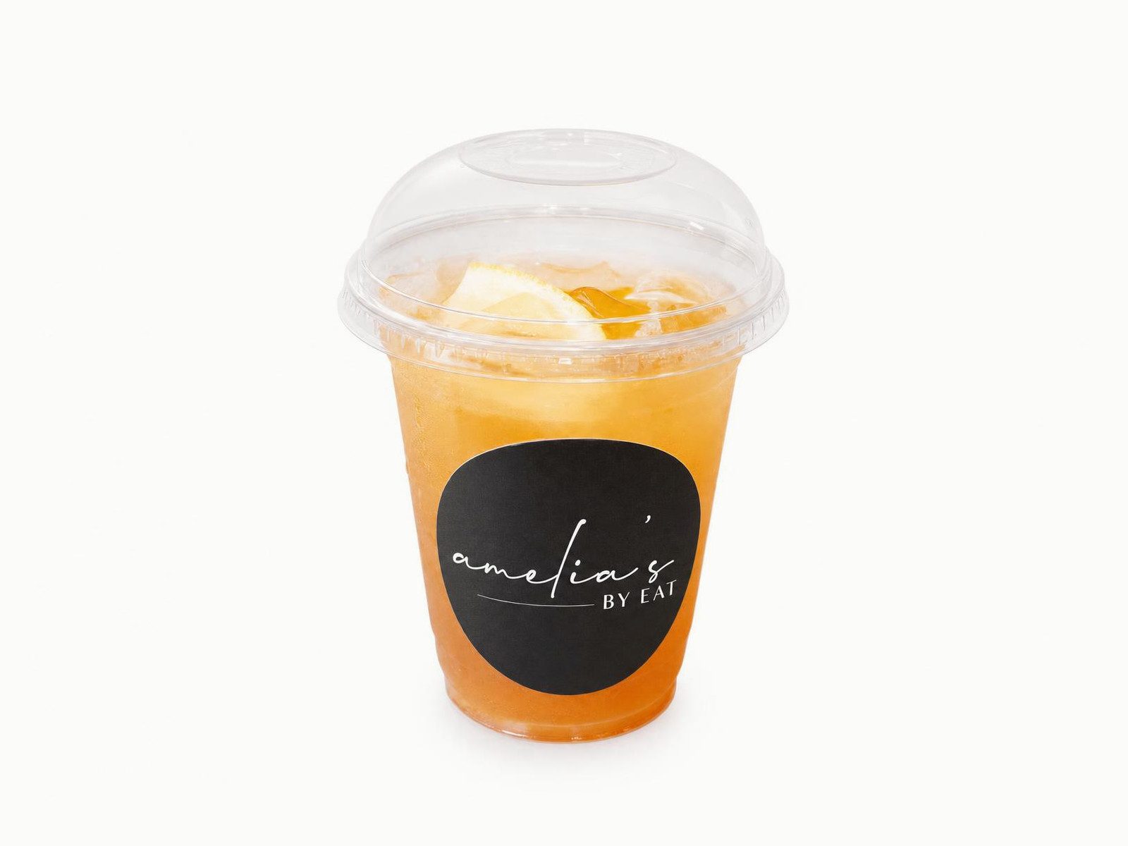 Arnold Palmer iced tea and lemonade with a lemon slice in a lidded Amelia's cup